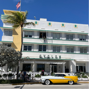 Yellow 1955 Oldsmobile parked in front of the Avalon Hotel on Ocean Drive